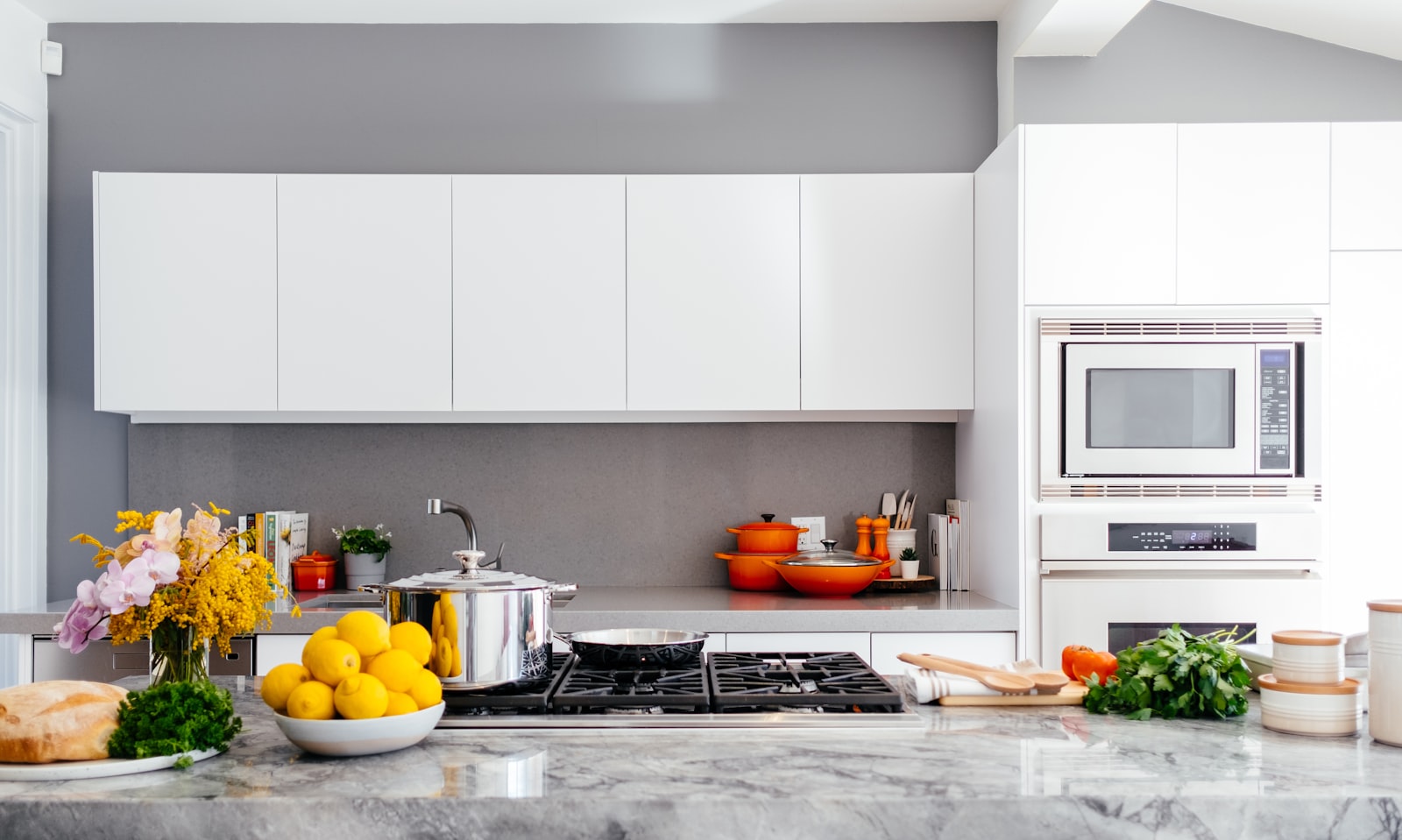 White kitchen with marble island installed by MG Flooring